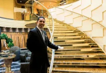 A Yacht Club butler serving guests